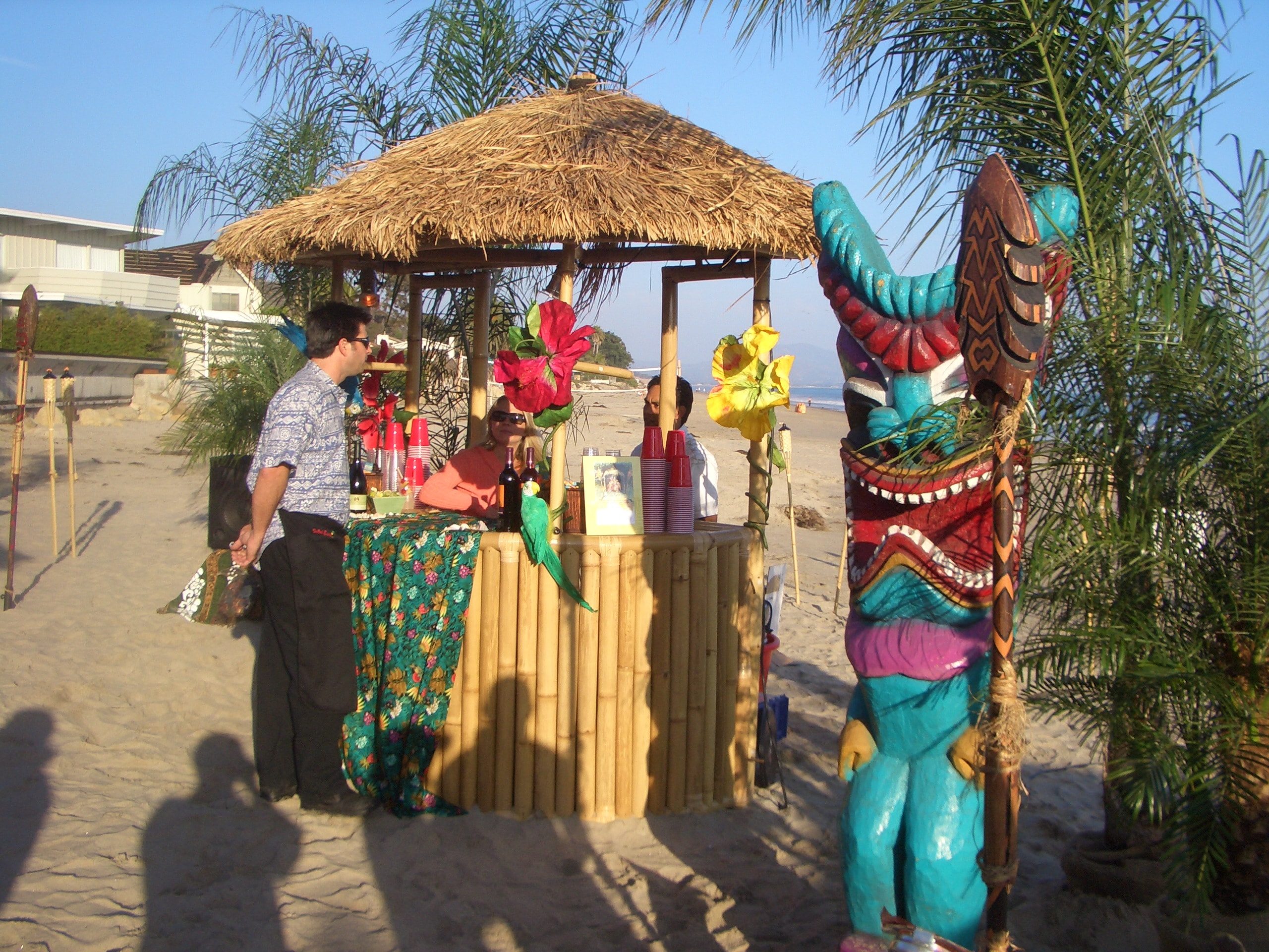 Elegant evening tiki lounge scene with string lights, tropical furniture and ambient lighting at a Manea Florida event